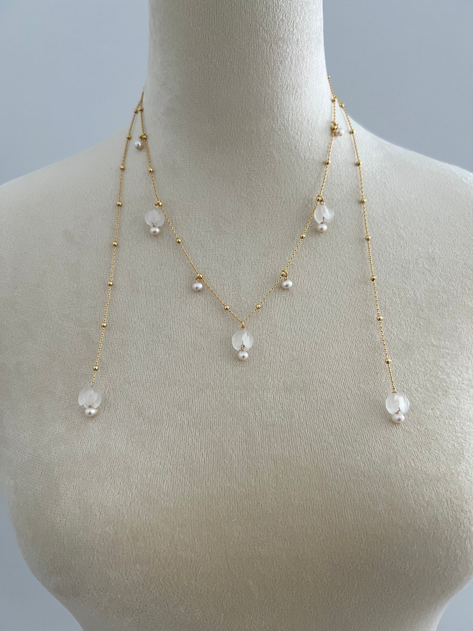 Lily of the valley layered necklace on a mannequin