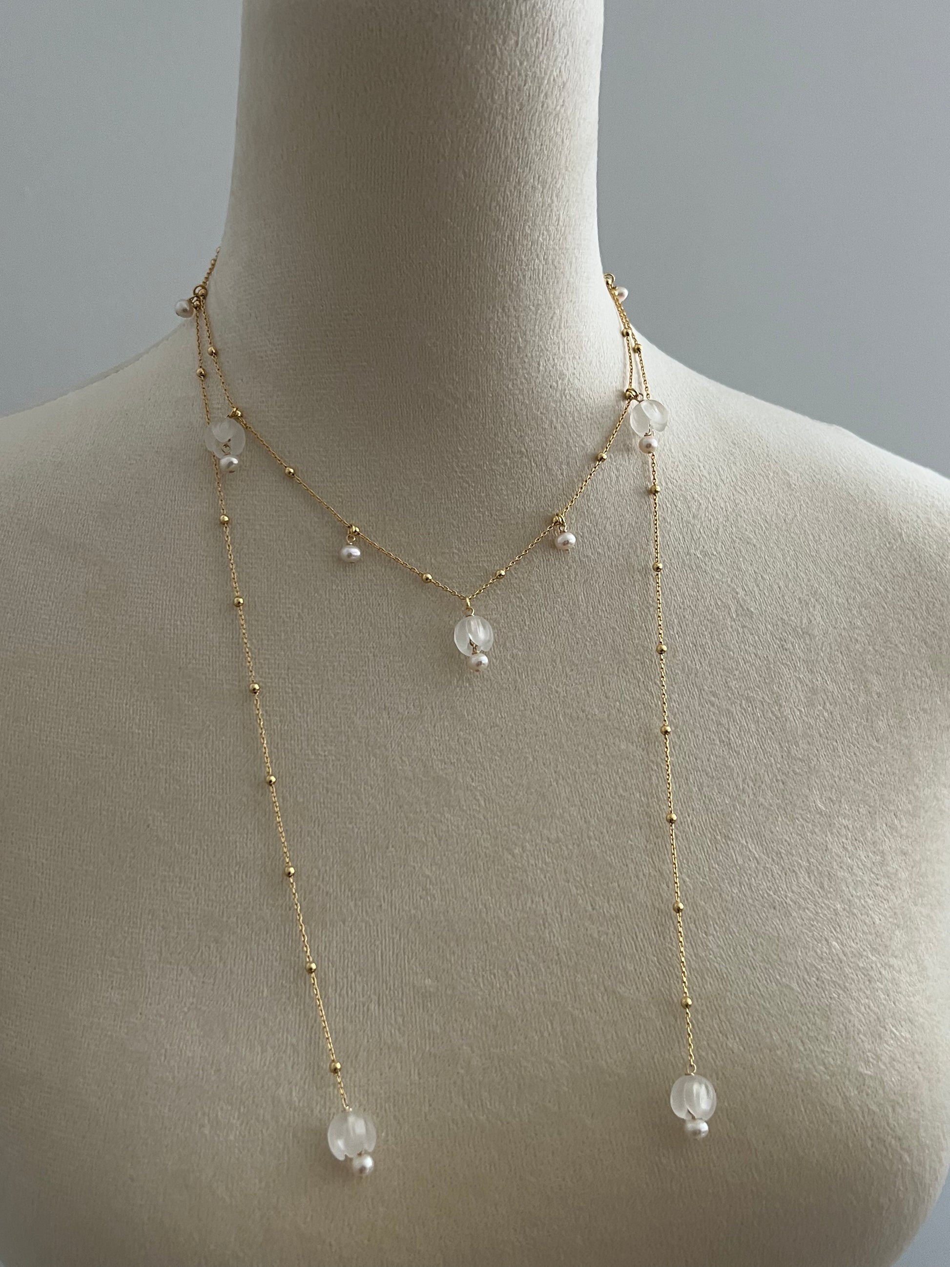 Lily of the valley layered necklace on a mannequin