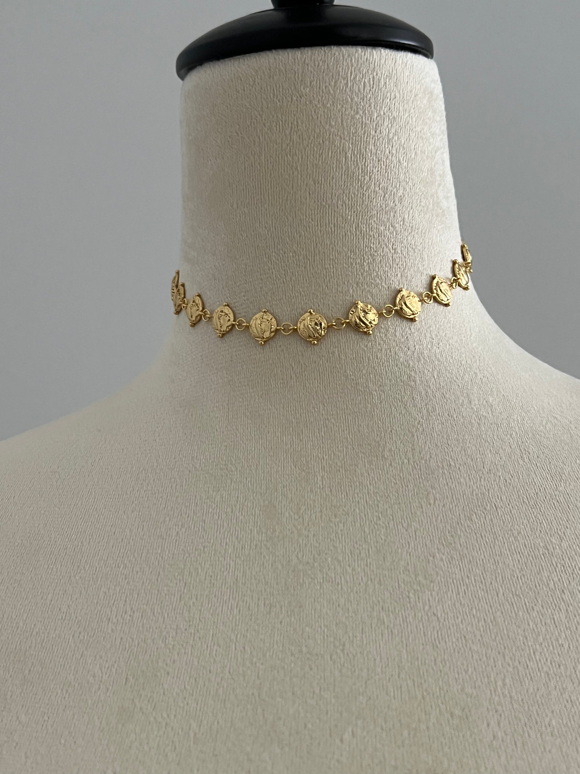 24k gold plated cascading coin choker necklace on a mannequin