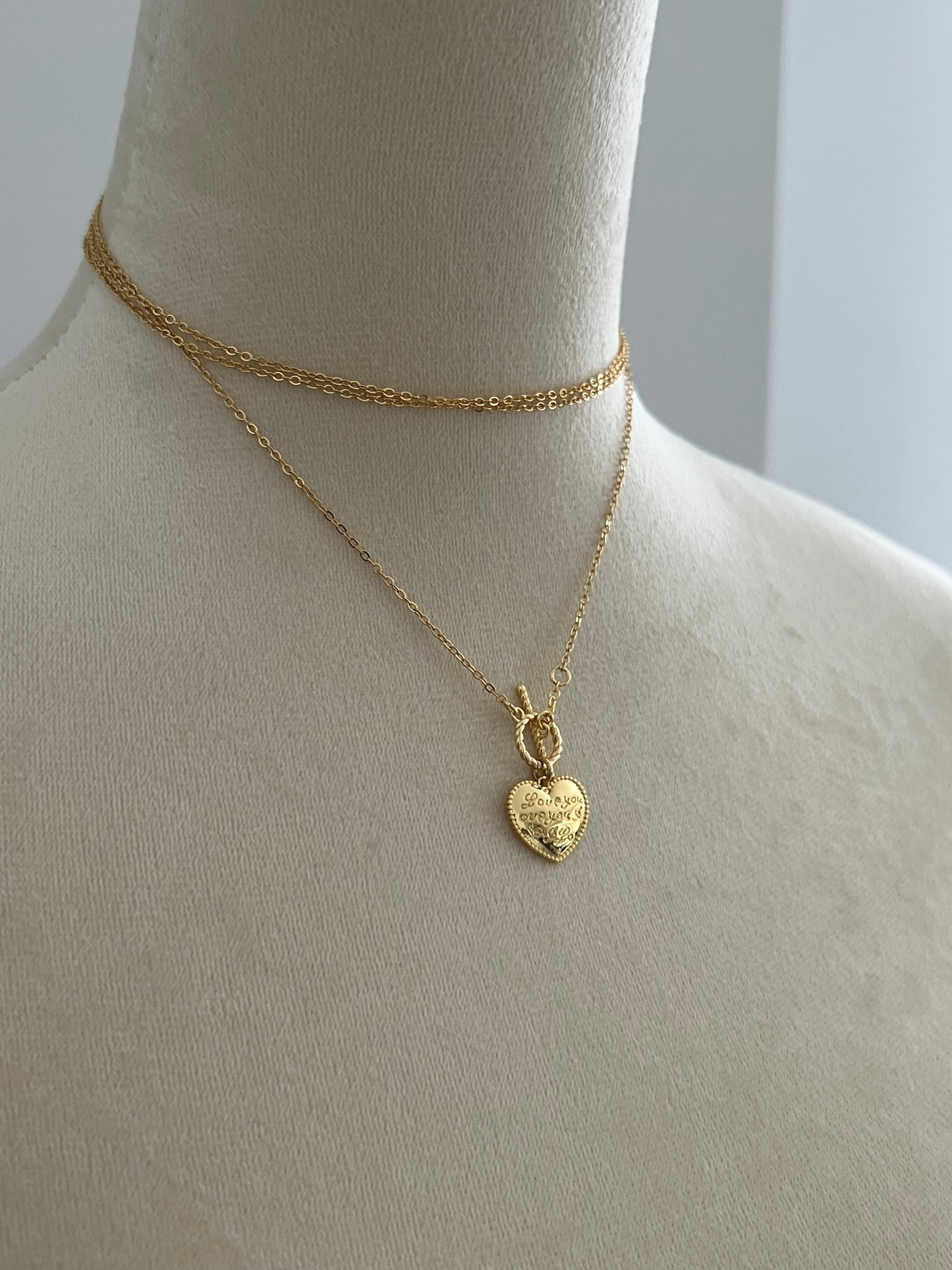 Gilder heart layered necklace on a mannequin