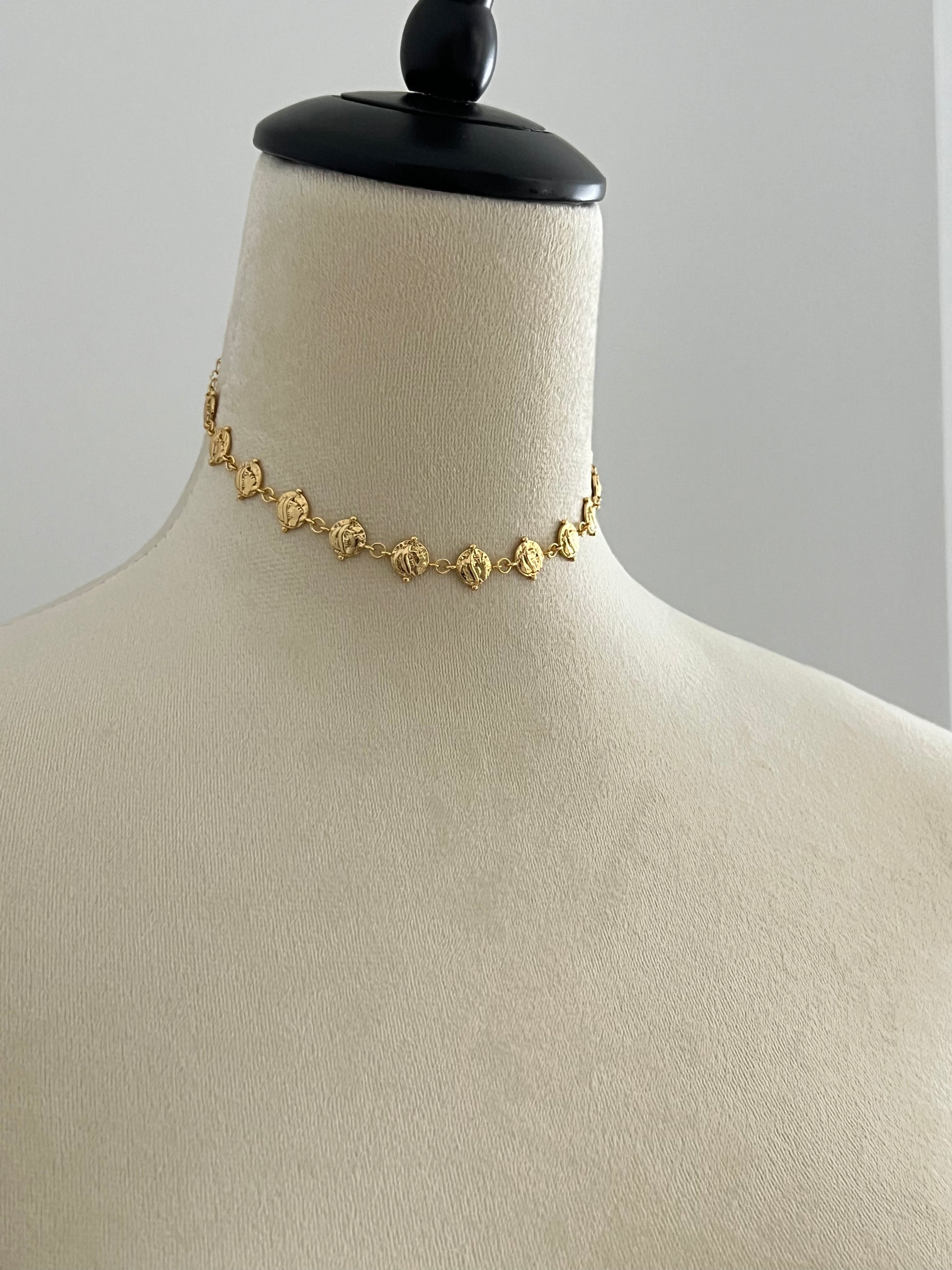 24k gold plated cascading coin choker necklace on a mannequin