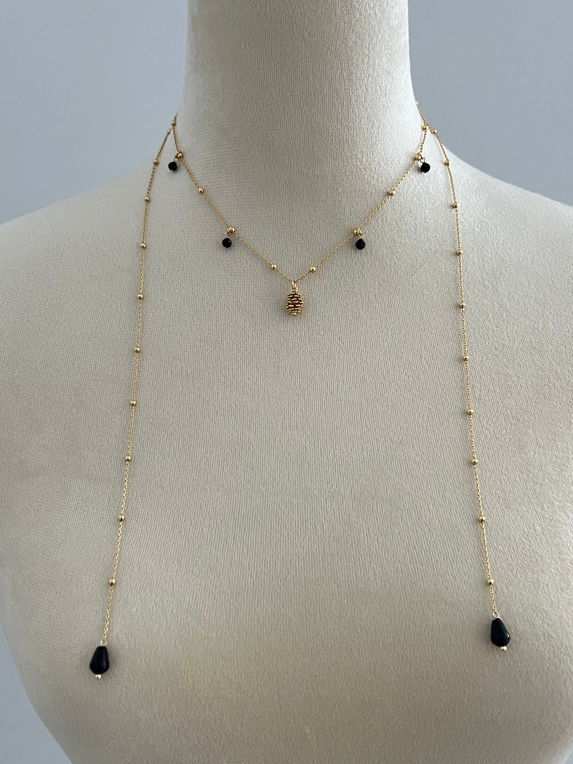 Pinecone layered necklace on a mannequin