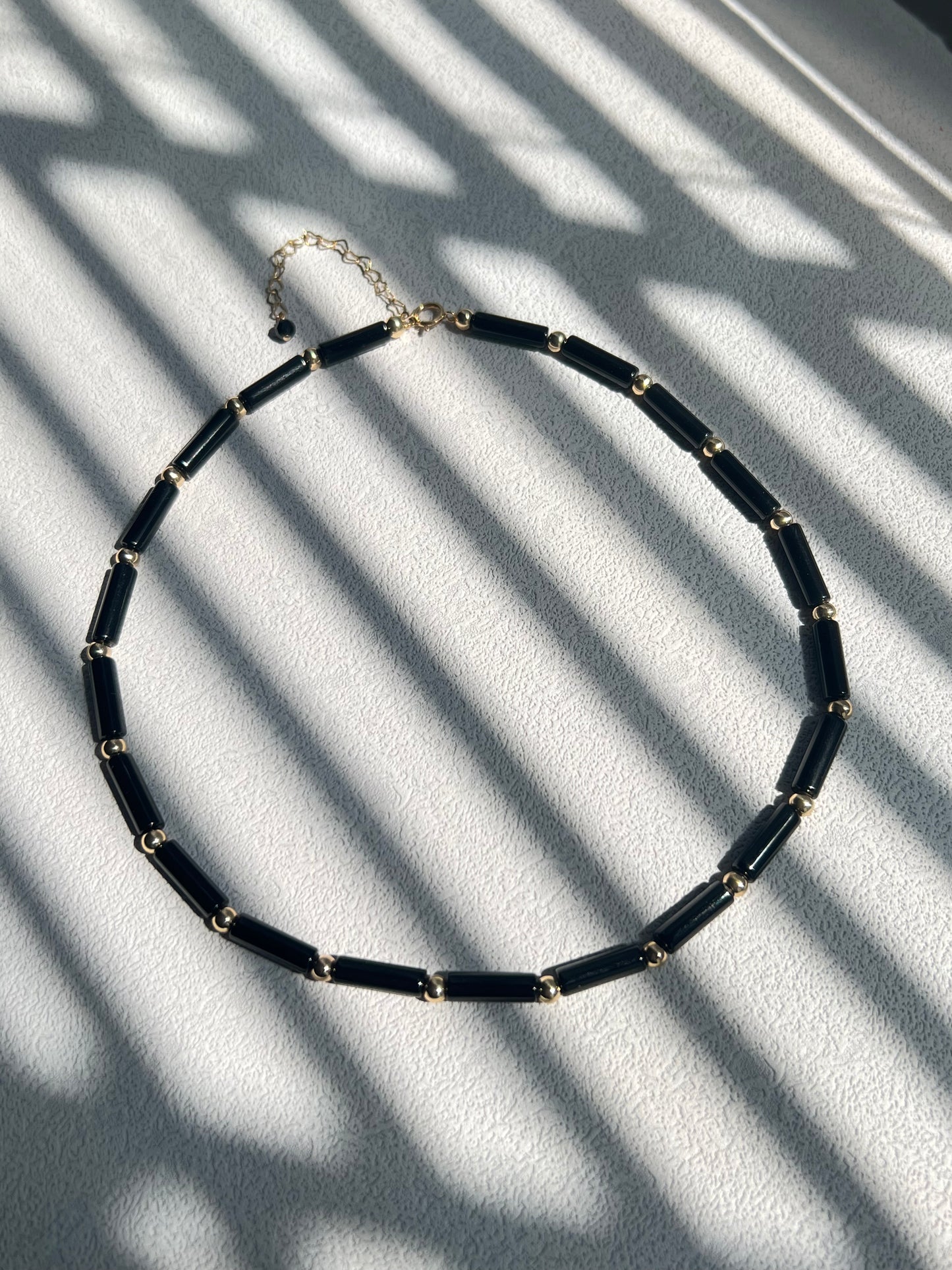 Black agate choker necklace under sunlight