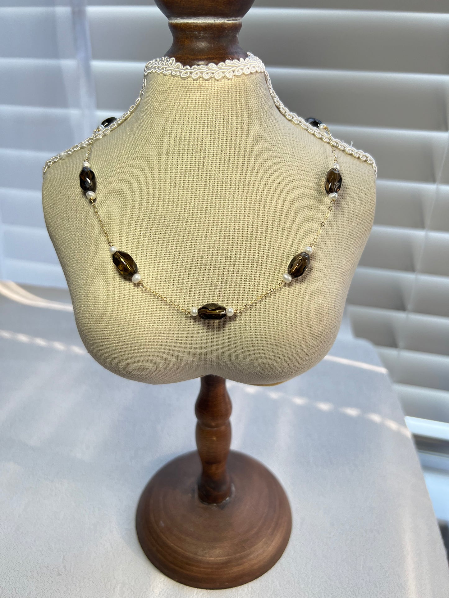 Smoky quartz & pearl choker necklace on a small mannequin