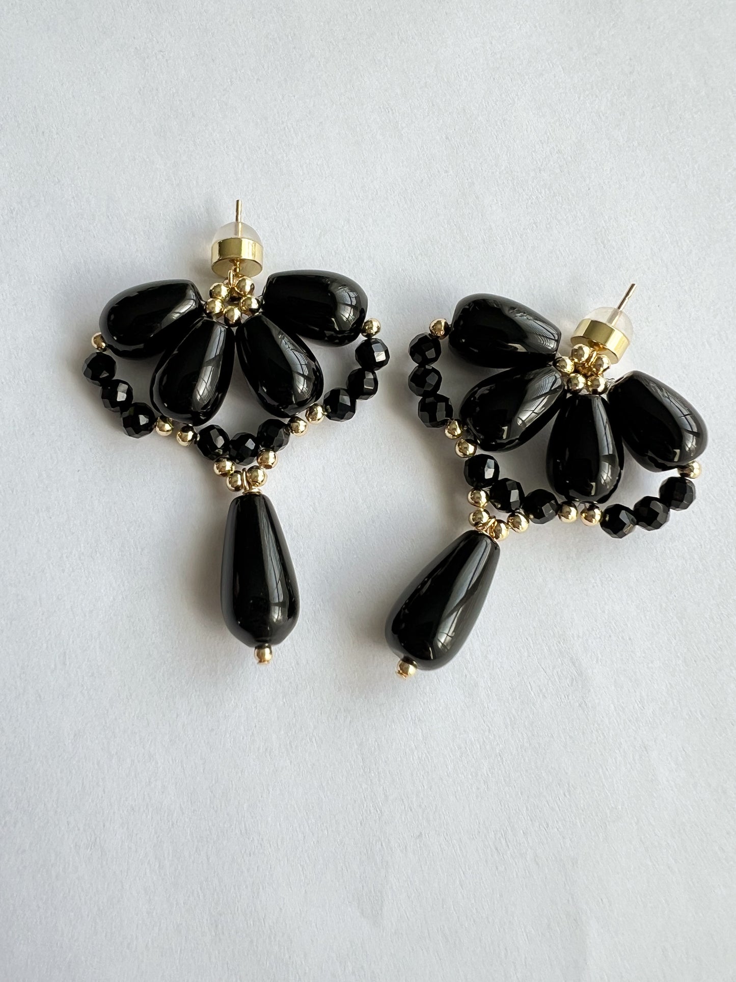 Black agate waterdrop earrings on a white paper