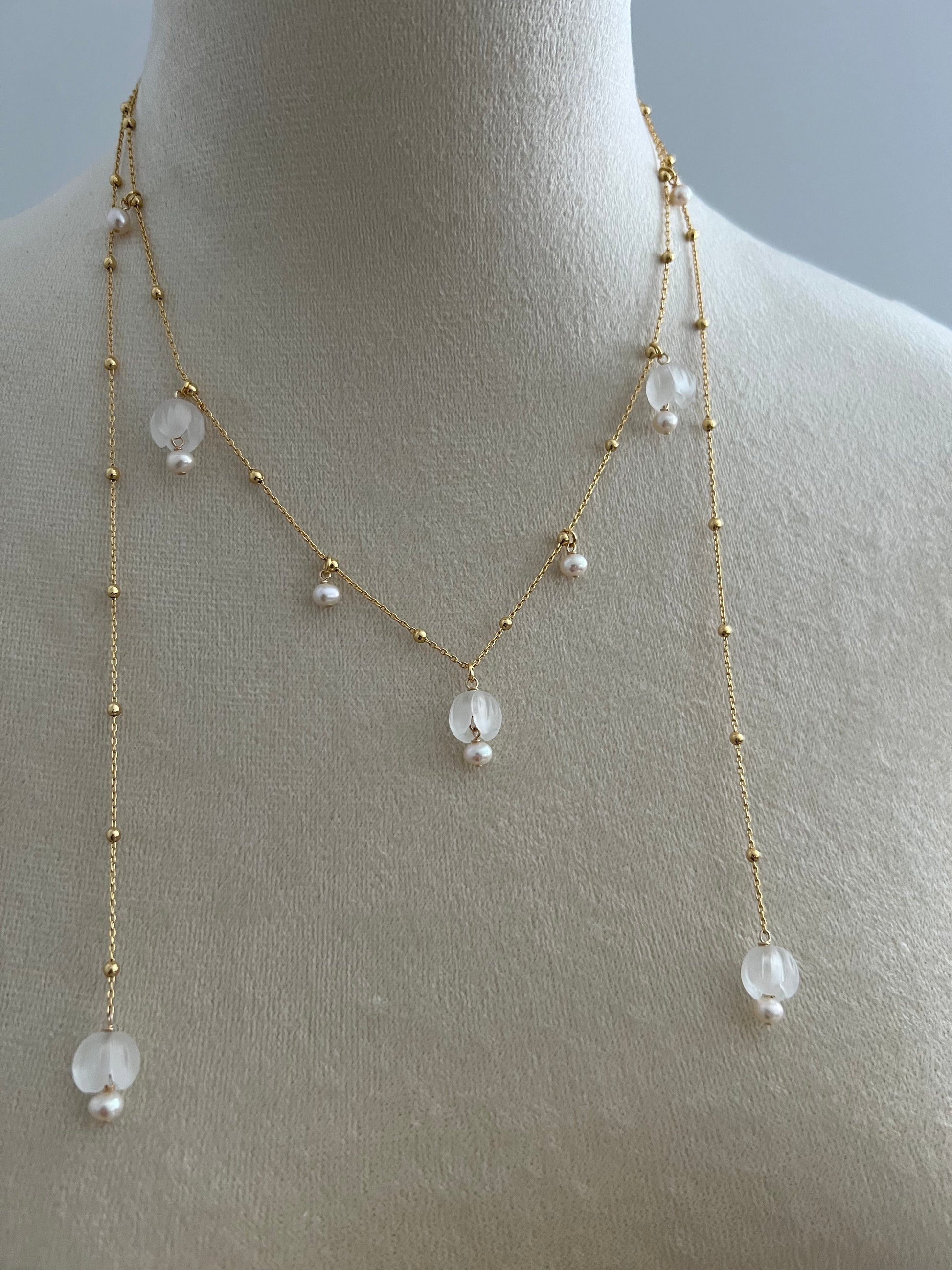 Lily of the valley layered necklace on a mannequin