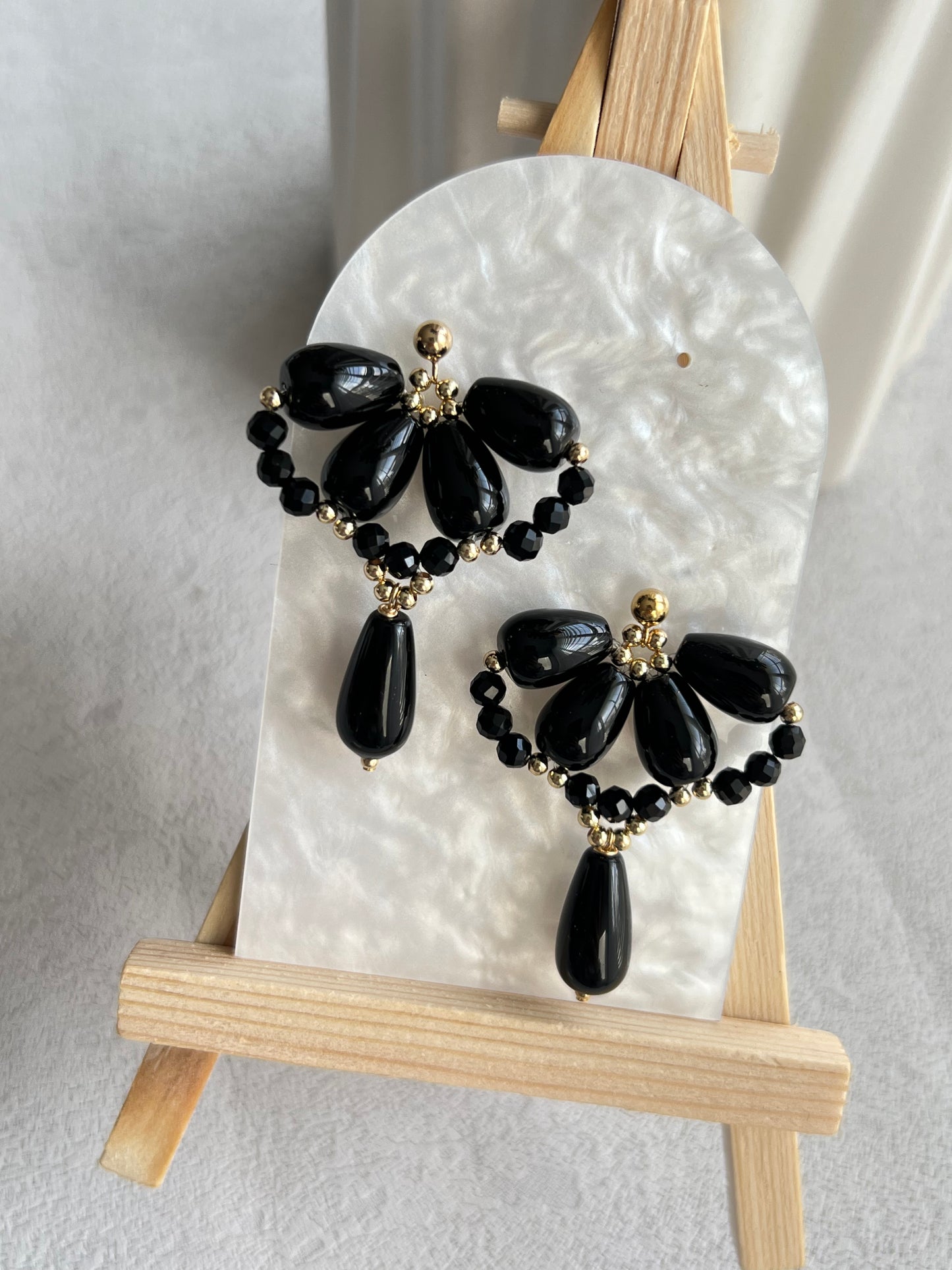 Black agate waterdrop earrings on a white board