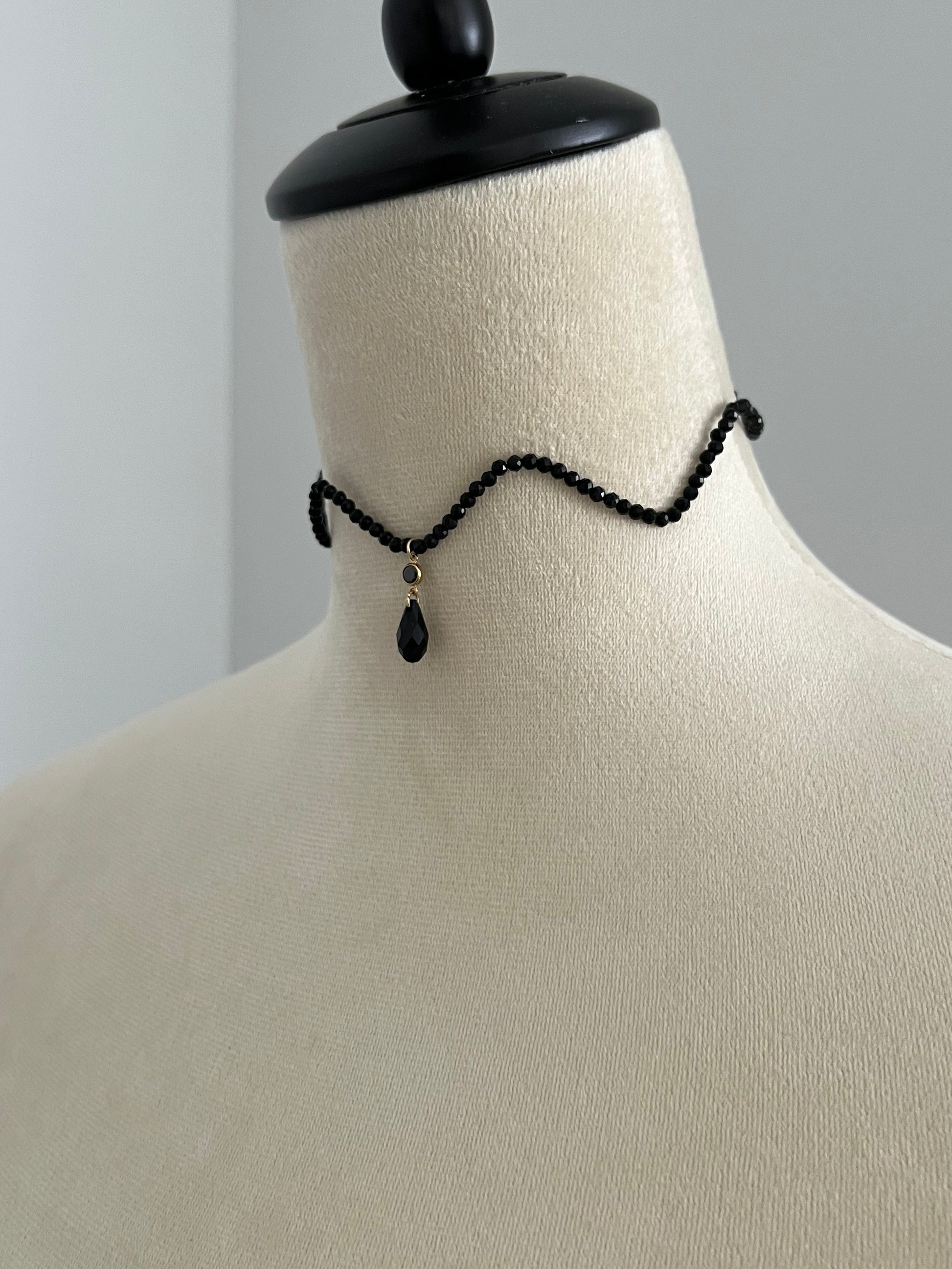 Black wave curve crystal choker necklace on a mannequin